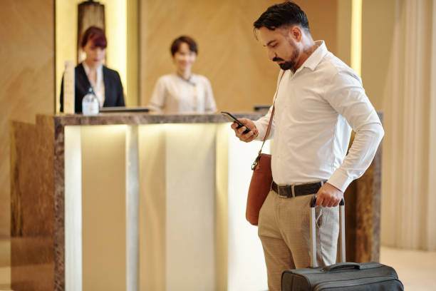 istock Hotel guest checking phone 1298257075