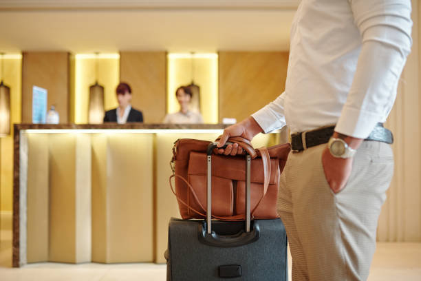 istock Hotel guest standing in lobby 1298257081