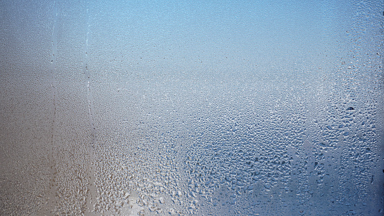 blurred glass window .Glass with water vapor,fog,stream. a window with water drops. fogged windows photo