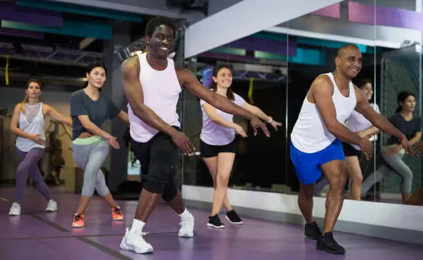 Photo of Emotional man doing exercises at dance class