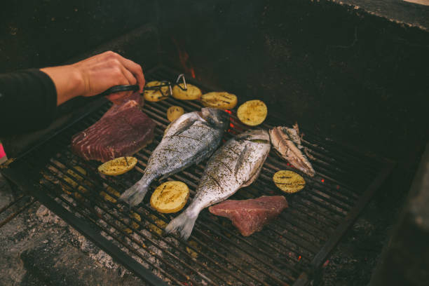 istock cooking fish and potatoes on grill 1298258351