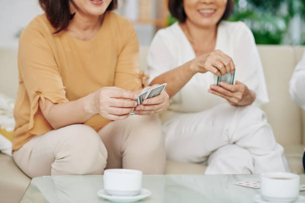 istock Female friends paying cards 1298258395