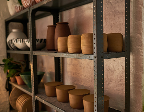 Shot of various vases and pots on a shelf in a pottery studio