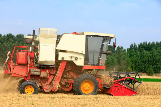 istock combine harvester working on a wheat field 1298261815