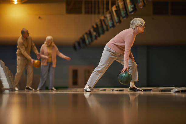 istock Active Senior Woman Playing Bowling Side View 1298262539