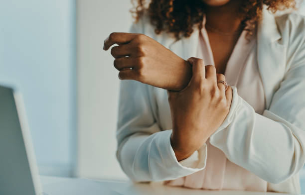 My wrist needs a bit of rest Shot of an unrecognisable businesswoman experiencing wrist pain while working in a modern office injured stock pictures, royalty-free photos & images