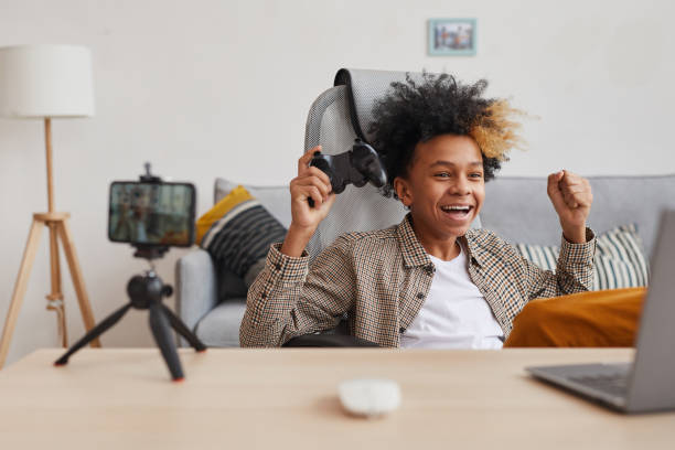 istock Excited African-American Boy Gaming at Home 1298264799