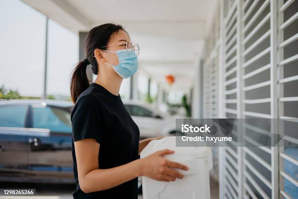 An Asian Chinese Woman Delivering Goods To Customer Stock Photo - Download Image Now