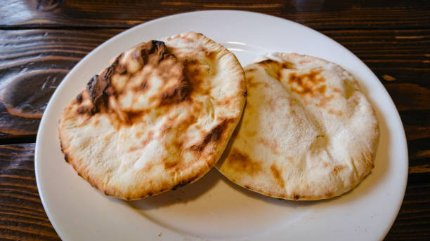 istock Two small bread tortillas stand in a plate on the table 1298265285