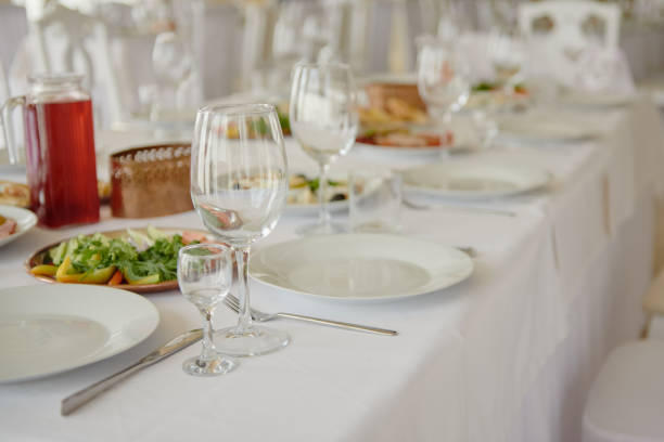 istock Table setting with wineglasses, plates and cutlery on table, copy space. Place setting at wedding reception. Table served for wedding banquet in restaurant 1298265874