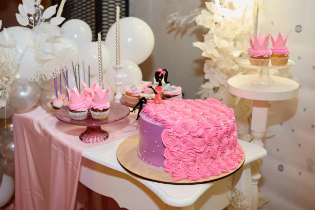 istock Candy bar served with pink cake, cupcakes, candles and balloons on table, copy space. Dessert table for party. Holiday or birthday concept 1298265901