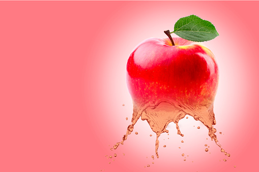 fresh fruit juice, red apple which liquefies on red background