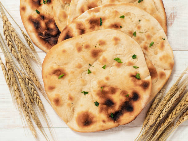 istock naan flatbreads on white wood, copy space, top view 1298269439