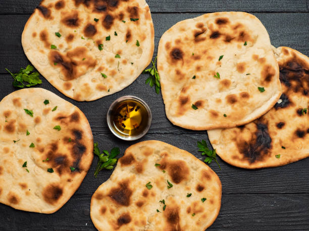 istock naan flatbreads on dark wood, copy space, top view 1298269676