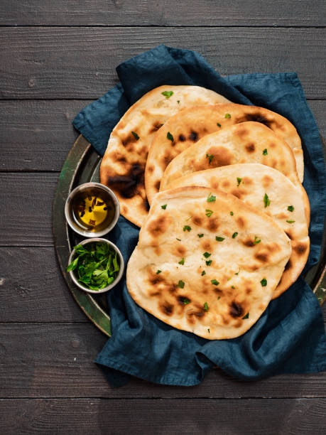 istock naan flatbreads on dark wood, copy space, vertical 1298269816