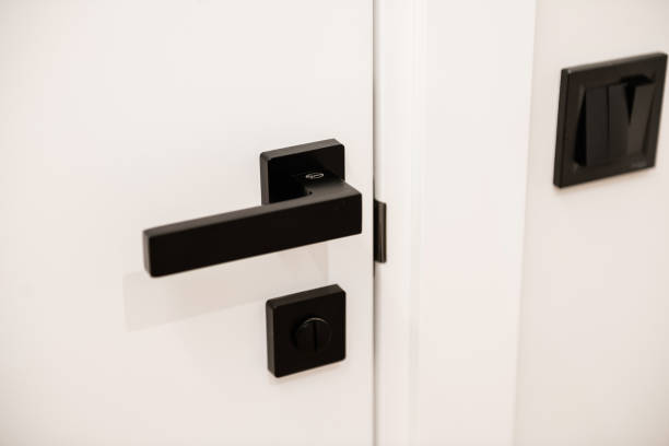 istock White door with black metal matte handle and black switch 1298270726