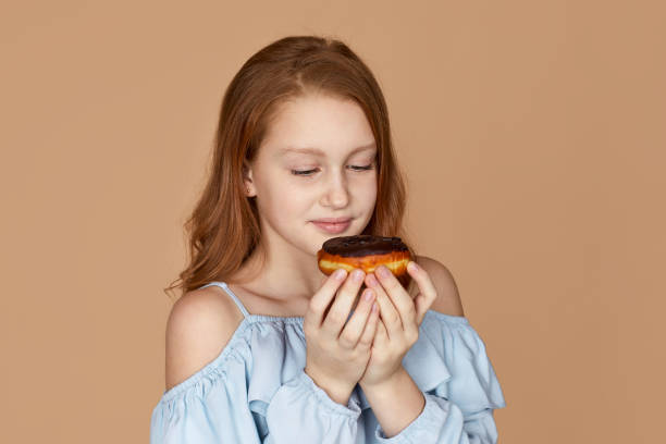 child girl holding yummy chocolate donut