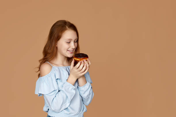 child girl holding yummy chocolate donut