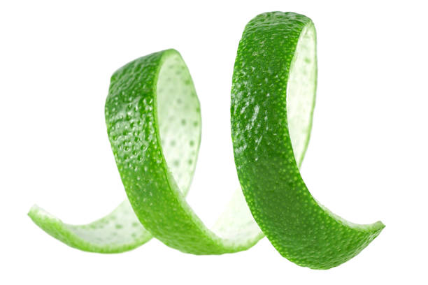istock Curly lime peel twist. Lime fruit peel isolated on a white background. 1298271099
