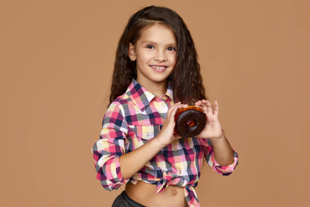 child girl holding yummy chocolate donut