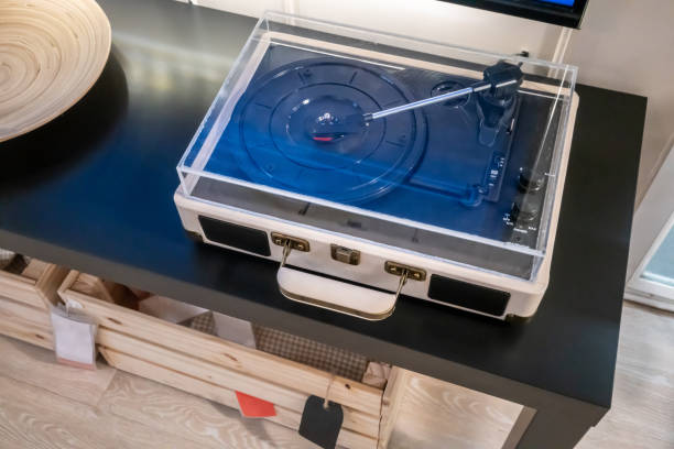 Turntable vinyl record player. Audio equipment for disc jockey on black table.