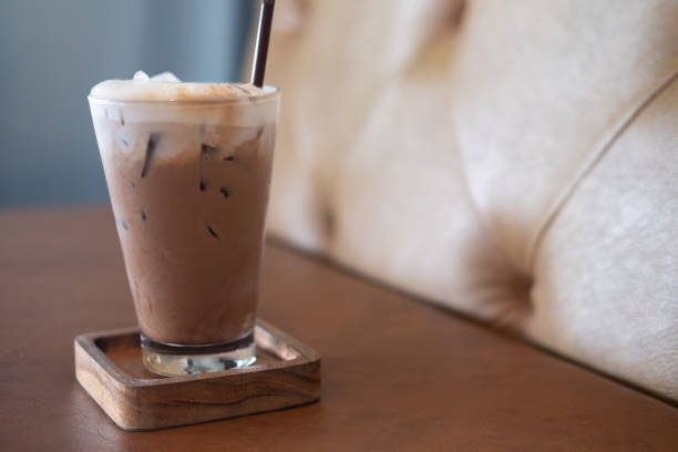 istock Iced Mocha coffee in glass on wood table at cafe. 1298273596