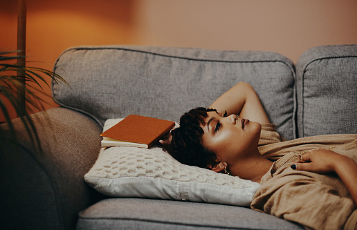 Shot of a beautiful young woman relaxing on the sofa at home