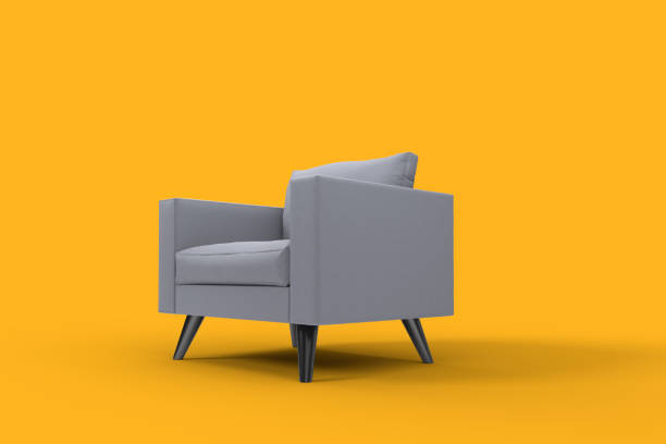 istock Grey armchair with pillows on studio yellow background. 1298275104