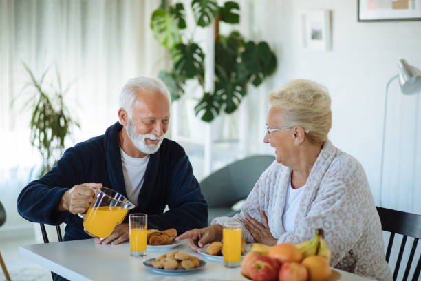 istock Beautiful senior couple having breakfast at home 1298275907