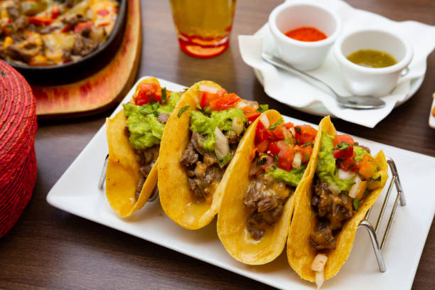 istock Mexican tacos with beef, guacamole and vegetables 1298276753