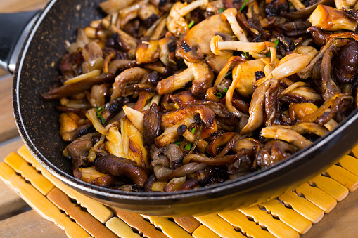 Close-up of  delicious freshly cooked fried oyster mushrooms  in a frying pan