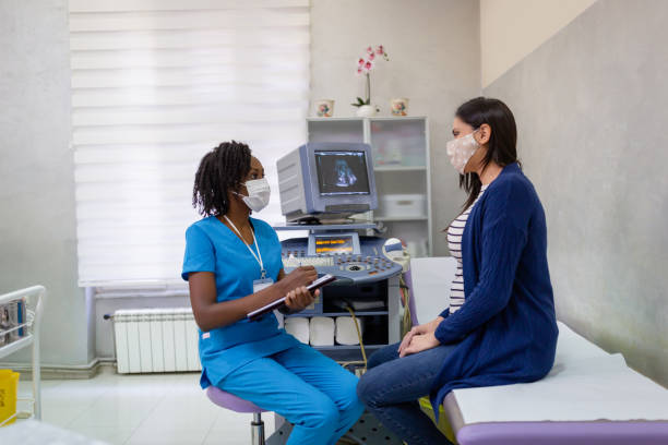 Pregnant woman on gynecological examination African-American female doctor doing gynecological examination gynecological examination photos stock pictures, royalty-free photos & images