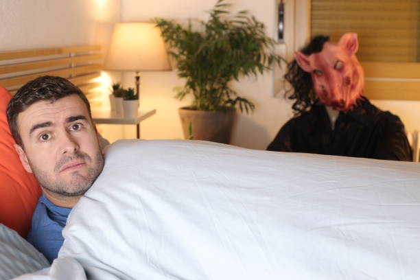 istock Terrified man seeing a monster in his bedroom 1298279133