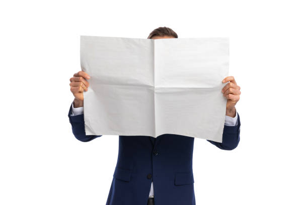 istock young elegant man in suit covering face with newspaper 1298279168