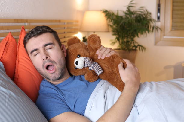 istock Adult sleeping with teddy bear 1298279820