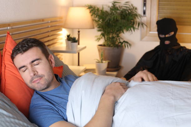 istock Man in bed surprised by an intruder 1298279906