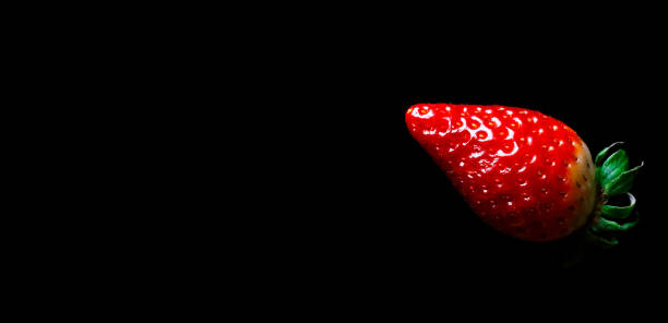 istock red ripe strawberry on a black background falling flying 1298280276