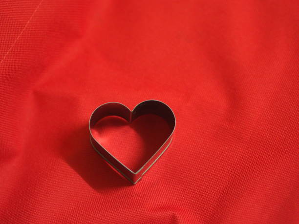 istock bread molds stainless Heart shaped on fabric red background, love Valentine Day for copy text card, background 1298280313