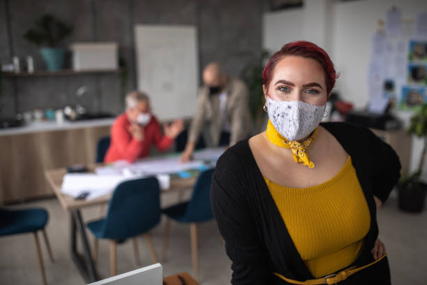 istock Successful businesswoman with protective face mask in office 1298280902