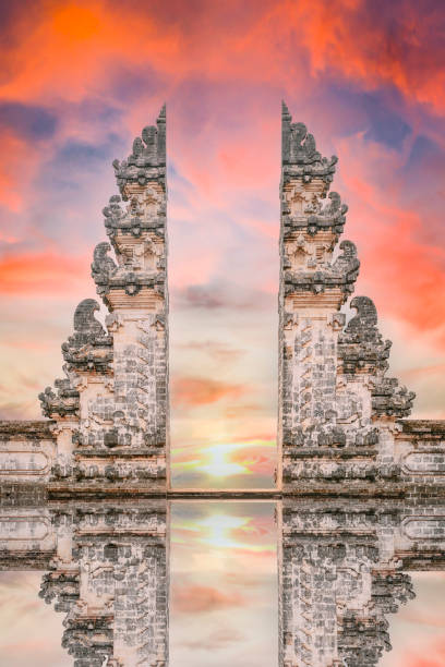 Stunning view of the Gate of Heaven with its reflection in the water during a beautiful sunset. Stunning view of the Gate of Heaven with its reflection in the water during a beautiful sunset. Pura Lempuyang it's a must-visit place for tourists who want to strike a pose in Bali, Indonesia. pool gate stock pictures, royalty-free photos & images