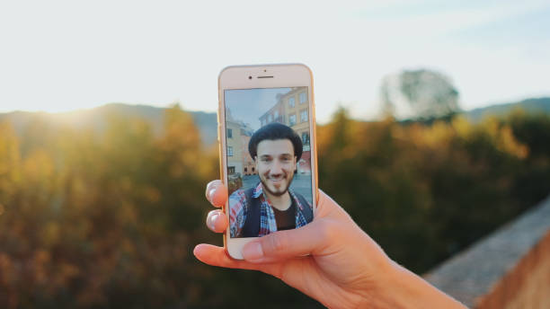 istock Man speaking on video call on smartphone 1298283005