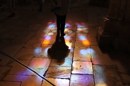 Batalha Monastery. Medieval gothic church in Portugal. UNESCO World Heritage Site. Colorful stained glass reflections on polished limestone floor.