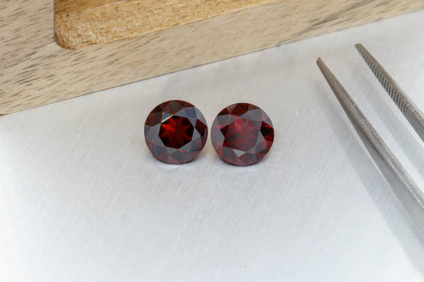 istock macro mineral faceted stone cut Garnet on a gray background 1298286112