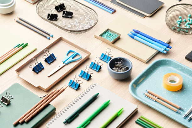 Table with various colorful stationery From above set of assorted office supplies arranged near various containers on desk office equipment stock pictures, royalty-free photos & images