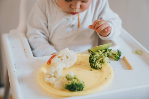 istock Baby eating vegetables 1298290479