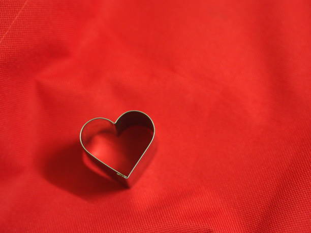 istock bread molds stainless Heart shaped on fabric red background, love Valentine Day for copy text card, background 1298291244