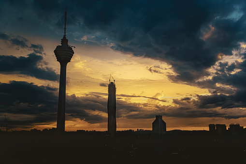 kuala lumpur city in silhouette during sunset with dramatic sky