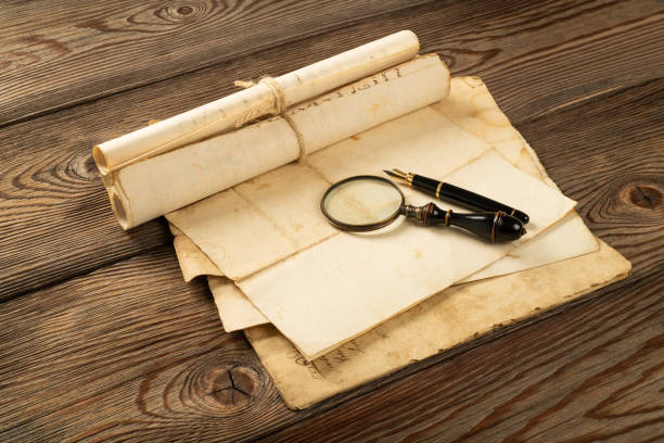 istock Fountain pen and magnifying glass with old sheets 1298293210