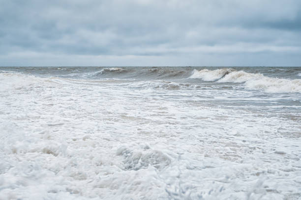 istock Dramatic minimalistic seascape with waves and white foam on the sea. 1298293288