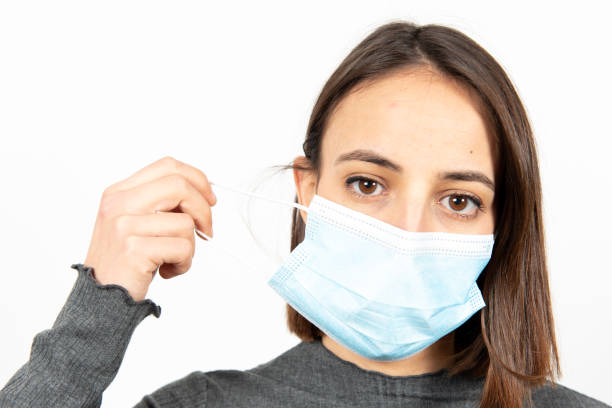 istock Hispanic girl with a face mask during pandemic 1298294572